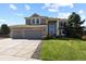 Charming two-story home featuring a three-car garage and a well-maintained front lawn at 11839 Saddleback Ct, Parker, CO 80138