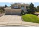 Two-story home featuring a three-car garage and manicured front yard with mature trees at 11839 Saddleback Ct, Parker, CO 80138