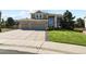 Two-story home with a three-car garage, large driveway, and well-manicured front yard at 11839 Saddleback Ct, Parker, CO 80138