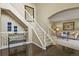 Elegant foyer with hardwood floors, staircase, and a view of the living area at 11839 Saddleback Ct, Parker, CO 80138