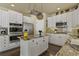 Open kitchen with white cabinets, an island, and stainless steel appliances at 11839 Saddleback Ct, Parker, CO 80138