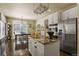 Kitchen island with granite countertop and an open layout to the dining area and appliances at 11839 Saddleback Ct, Parker, CO 80138