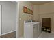 Functional laundry room with modern washer and dryer, storage cabinet, and easy access to the rest of the house at 11839 Saddleback Ct, Parker, CO 80138