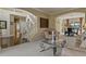 Comfortable living room with neutral tones, staircase, and a view into the dining area at 11839 Saddleback Ct, Parker, CO 80138