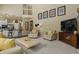 Open concept living area with views of the kitchen and staircase with neutral colors and ample seating at 11839 Saddleback Ct, Parker, CO 80138