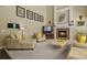 Cozy living room with a fireplace, high ceilings, and neutral-toned furniture at 11839 Saddleback Ct, Parker, CO 80138