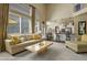 Bright living room open to kitchen with plenty of natural light, cozy seating, and modern finishes at 11839 Saddleback Ct, Parker, CO 80138