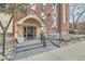 Riviera Park Condominiums entryway with decorative stonework and professional landscaping at 1008 N Corona St # 205, Denver, CO 80218