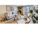 Cozy living room with stone fireplace, comfortable seating, and natural light at 1008 N Corona St # 205, Denver, CO 80218