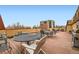 Expansive rooftop deck with plenty of seating, outdoor dining area, and views of the surrounding neighborhood at 1008 N Corona St # 205, Denver, CO 80218