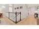 Upstairs hallway with hardwood floors and elegant staircase at 18081 W 94Th Ln, Arvada, CO 80007