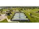 Aerial view of community tennis courts surrounded by lush greenery and trees at 707 Uvalda St, Aurora, CO 80011