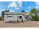 Well-maintained single-story home featuring gray siding and manicured front yard at 707 Uvalda St, Aurora, CO 80011