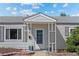 Covered front door entryway with brick borders and light gray siding at 707 Uvalda St, Aurora, CO 80011