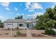 Single-story home with well-kept landscaping and inviting pathway to the front door at 707 Uvalda St, Aurora, CO 80011