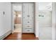 Hallway view features a bathroom, built in storage, and doorway to bedroom at 707 Uvalda St, Aurora, CO 80011