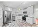Well-lit kitchen with stainless steel refrigerator and modern appliances at 707 Uvalda St, Aurora, CO 80011