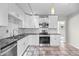 Bright kitchen featuring white cabinetry, modern appliances, and stylish tile flooring at 707 Uvalda St, Aurora, CO 80011