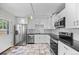 Modern kitchen with stainless steel appliances and sleek black countertops at 707 Uvalda St, Aurora, CO 80011