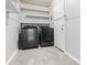 This laundry room features shelving and new washer/dryer units at 707 Uvalda St, Aurora, CO 80011
