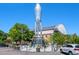 Outdoor shot of a rocket sculpture in a public space featuring a glass-enclosed base with tables and chairs at 707 Uvalda St, Aurora, CO 80011
