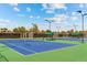 Well-maintained tennis courts with blue and green surfaces, surrounded by trees at 707 Uvalda St, Aurora, CO 80011