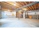 Unfinished basement with exposed beams and utility connections at 14221 Ivanhoe St, Thornton, CO 80602