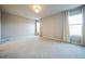 Spacious bedroom with neutral carpeting, large windows with curtains, and ample natural light at 14221 Ivanhoe St, Thornton, CO 80602