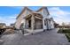 Two-story home featuring light blue siding, stone accents, and a covered patio with stairs at 14221 Ivanhoe St, Thornton, CO 80602