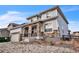 Stylish two-story home showing attached garage, stone accents, tidy landscaping, and architectural detail at 14221 Ivanhoe St, Thornton, CO 80602