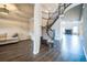 Elegant foyer featuring hardwood floors, a curved staircase, and a view of the living room at 14221 Ivanhoe St, Thornton, CO 80602
