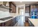 Well-equipped kitchen with gas cooktop, stainless steel appliances, and ample counter space at 14221 Ivanhoe St, Thornton, CO 80602