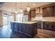 Modern kitchen boasting a central island, stainless steel appliances, and custom cabinetry at 14221 Ivanhoe St, Thornton, CO 80602