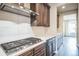 Modern kitchen showcasing gas cooktop, stainless steel appliances, and custom cabinetry at 14221 Ivanhoe St, Thornton, CO 80602