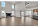 Spacious living area with a stone fireplace, hardwood floors, and large windows at 14221 Ivanhoe St, Thornton, CO 80602