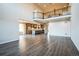 Open-concept living room showcasing hardwood floors and seamless flow into the kitchen at 14221 Ivanhoe St, Thornton, CO 80602