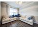 Cozy sitting area with plush sectional sofa, hardwood floors, and ample natural light at 14221 Ivanhoe St, Thornton, CO 80602