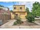 Backyard with flowers, partial fence, and building view from behind at 7 Elati St, Denver, CO 80223