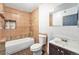 Bathroom showcasing a tub, toilet, sink, and tiled walls at 7 Elati St, Denver, CO 80223