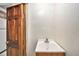 Small bathroom featuring a pedestal sink next to a dark wood door at 7 Elati St, Denver, CO 80223