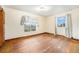Bedroom features hardwood floors, white walls, and large windows for plenty of light at 7 Elati St, Denver, CO 80223