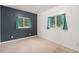 Bedroom featuring tile floors, two windows with green curtains, and dark accent wall at 7 Elati St, Denver, CO 80223