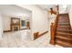 Foyer view featuring a beautiful hardwood staircase, tiled floors and a view into the living room at 7 Elati St, Denver, CO 80223