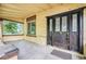 Inviting front porch featuring a beautiful ornate door, large window, and concrete floor at 7 Elati St, Denver, CO 80223