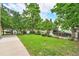 The lush front yard of the property has roses and lawn at 7 Elati St, Denver, CO 80223