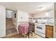 Kitchen with tile floor, an oven, microwave, and a table with checkered table cloth at 7 Elati St, Denver, CO 80223