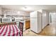 Kitchen featuring tile floors, an oven, microwave, fridge and dining area at 7 Elati St, Denver, CO 80223