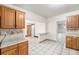 Bright kitchen featuring wood cabinets, neutral countertops, and decorative tile flooring at 7 Elati St, Denver, CO 80223