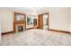 Bright living room featuring a decorative fireplace, chandelier, and tiled floors at 7 Elati St, Denver, CO 80223