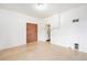 Open-concept living room with tile floors, brick accent wall, and white walls at 7 Elati St, Denver, CO 80223